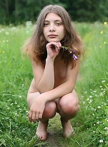 Cute brunette nude in a field