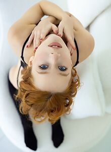 Freckled redhead with blue eyes in lingerie
