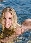 Stunning blonde with huge areolas naked in the sea