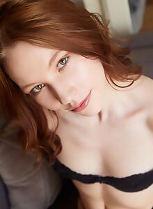 Beautiful redhead babe Maya Sinn teases in black lingerie before stripping and spreading