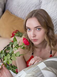 Blue-eyed blonde girl exposes her big pussy lips on the couch