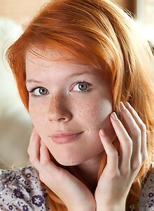 Gorgeous freckled redhead spreads her legs