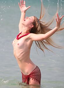 Blonde girl nude in the sea