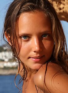 Tanned blonde girl nude in the sun