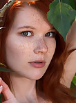 Shaved freckled redhead nude in a creek