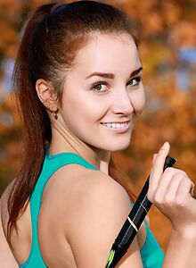 Freckled brunette with dimples spreading in a field