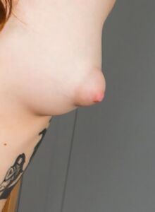 Tattooed redhead with puffy nipples masturbating