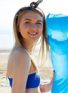 Flat-chested blonde teen spreading at the beach