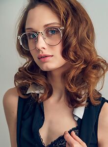 Flat-chested redhead with glasses stripping