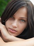 Brunette teen with amazing eyes nude by a river