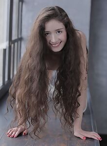 Long-haired brunette teen posing in long socks