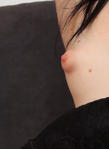 Black-haired teen with puffy nipples toying her shaved pussy