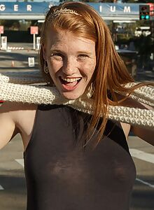 Freckled redhead teen flashes her tits