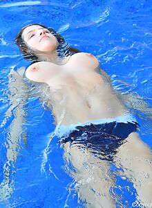 Busty amateur stripping in the pool