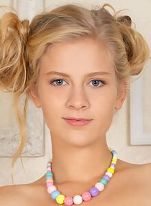 Blonde teen with blue eyes spreading on a chair