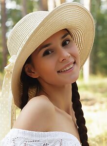 Cute brunette teen Leona Mia spreading in a field