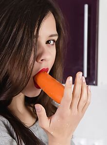 Cute brunette teen toying with carrot