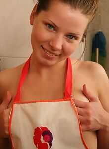 Cute redhead teen with freckles shows off her tan lines in the kitchen