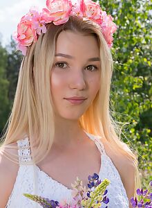 Adorable blonde teen nude in a field