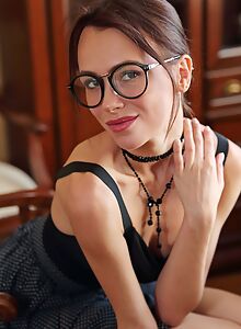 Sexy brunette with glasses lifts up her skirt