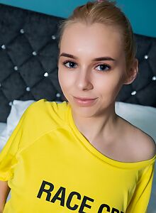 Cute blonde teen with blue eyes shows off her bald pussy