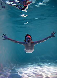 Cute girl nude underwater in a swimming pool