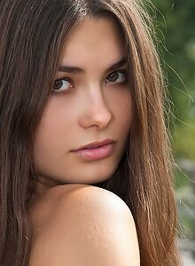 Perfect brunette naked on a pier