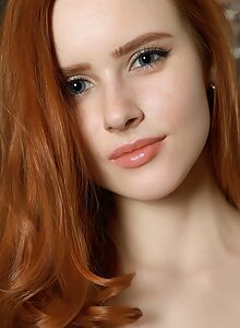 Blue-eyed redhead teen with small tits posing nude