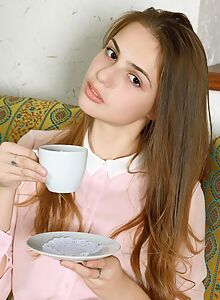 Long-haired brunette teen spreading on the couch