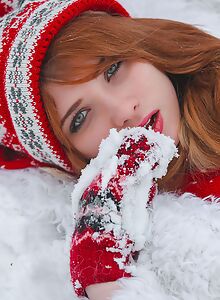 Cute redhead stripping naked in the snow