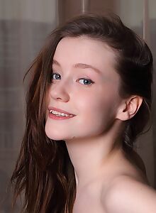 Busty brunette teen with pale skin posing