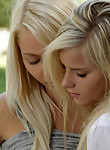 Blonde lesbians licking each other in a park