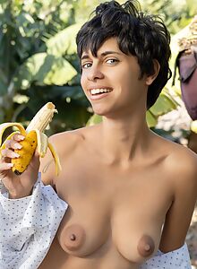 Short-haired brunette exposes her big areolas in the jungle