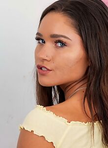 Tanned brunette with small tits spreads her asshole