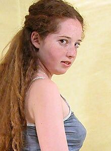 Freckled redhead with firm boobs exposes her hairy pussy