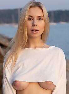 Curvy blonde with huge boobs and saucer nipples naked at the beach