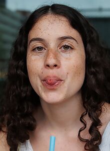 Freckled brunette flashes her tits in the rain