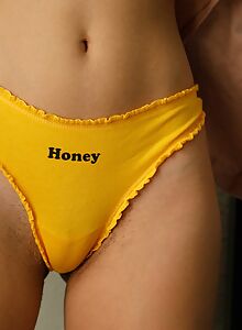 Sexy black-haired girl in a yellow thong