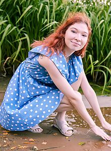Flat-chested redhead Mia Murkovski spreads her shaved pussy by a lake