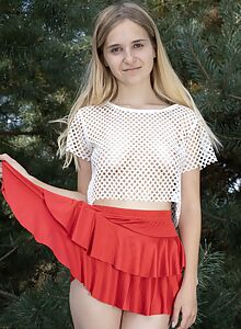 Cute shaved blonde lifts up her skirt outdoors