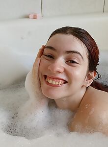 Cute redhead with big tits bathing