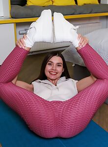 Flexible girl with blue eyes in the bathtub