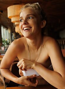 Blonde girl flashes her tits in a restaurant