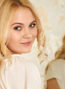 Lovely shaved blonde posing nude