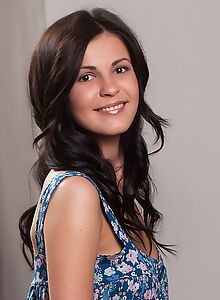 Tanned brunette nude on the couch