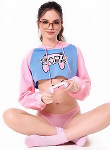 Nerdy brunette gamer with small tits toying her shaved pussy