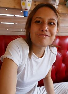 Cute freckled girl topless in her bedroom