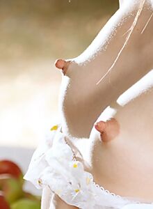 Cute brunette with insanely long nipples naked in the backyard