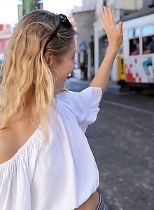 Flat-chested blonde posing around town