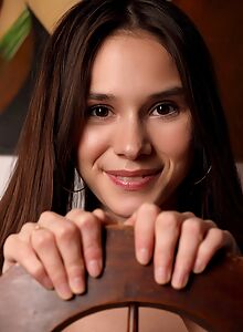 Skinny brunette teen spreading on a chair